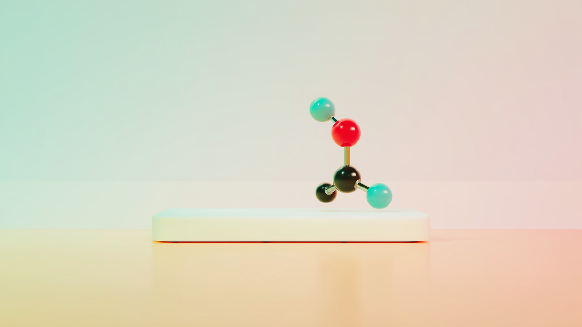 A ball-and-stick molecule model with colored spheres floats above a pastel pedestal.